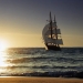 sailing ship emerging from ocean